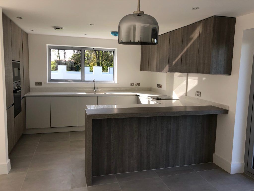 Leicht kitchen with a dark wood island in one of the St Merryn houses