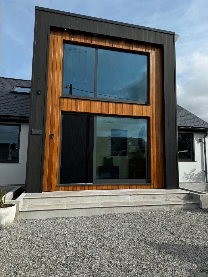 Timber-clad gable and full-height glazing at Mordros, Trevone