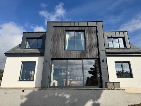Front elevation at Southpark Road, Tywardreath, with dark cladding between the dormers